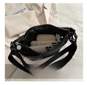 Detail view of the spacious inner compartment of the black quilted crossbody cloud bag