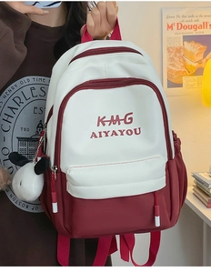 Detail of red and white backpack featuring plush dog pendant in a vintage room setting