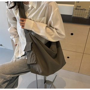 Macro detail of the durable waterproof fabric and side pocket on this large crossbody bag