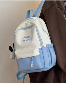 Close-up of sky blue polyester backpack with panda charm and KMH AIYAYOU lettering