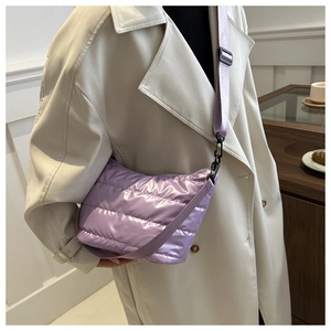 Detail of lavender quilted puffer crossbody bag with nylon texture and metal hook