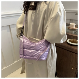 Close-up of a stylish quilted purple puffer bag featuring premium metallic sheen texture