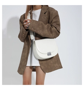 Détail du sac besace blanc avec boucle en métal argenté et bandoulière large