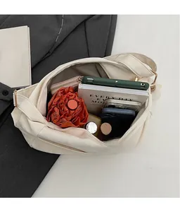 Top view of cream-colored shoulder bag showing spacious interior with daily essentials
