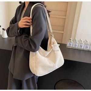Detail of white large capacity PU hobo bag with a cute plush sheep pendant for women