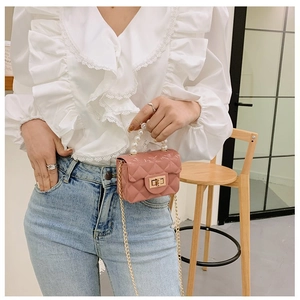 Détail du mini sac matelassé rose avec poignée en perles et bandoulière dorée