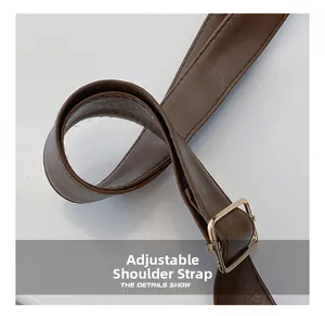 Detailed close-up of the dark brown adjustable faux leather strap with golden metal buckle
