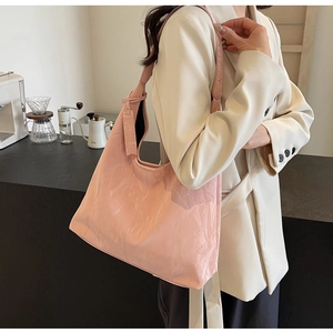 Detail of soft pale pink PU leather hobo bag showing wrinkled texture and large capacity