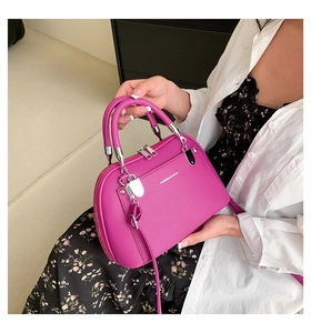 Détail du sac à main magenta en cuir PU avec texture grainée et logo mode