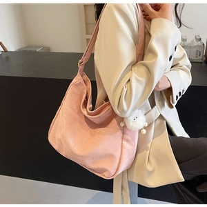 Pink large-capacity PU shoulder bag featuring a cute plush monster charm and side stitching