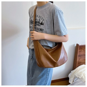 Detail showing high-quality brown PU leather texture and large capacity hobo bag design