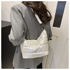 Detail view of quilted puffer shoulder bag with a soft pearlescent white texture finish