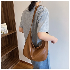 Detail view of brown PU leather hobo bag showing soft texture and adjustable strap