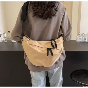 Detailed back view of a khaki crescent nylon crossbody bag with wide shoulder strap