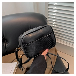 Classic black PU leather crossbody bag featuring V-shaped stitching and tassel charm