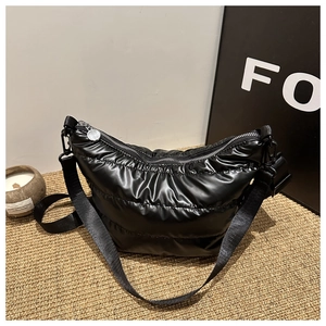 Chic black quilted nylon crescent crossbody bag with wide shoulder strap and silver hardware