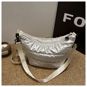 Silver quilted crossbody bag with metallic sheen and white nylon strap for women