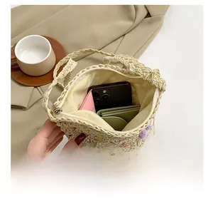 Straw bag interior detail showing space for smartphone, wallet and card holder