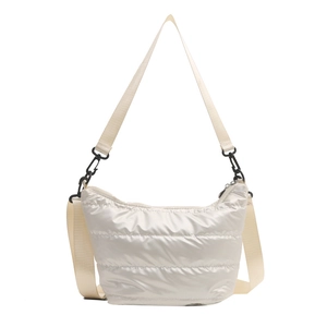 Minimalist ivory quilted puffer crossbody bag with matching wide strap and black buckles