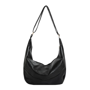 Minimalist black crescent crossbody bag in polished faux leather with adjustable strap