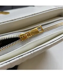 Close-up of premium white PU leather texture with high-quality golden metal zipper detail