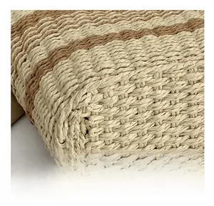 Macro shot of the detailed woven texture and two-tone striped pattern on this handbag