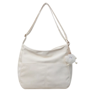 Minimalist white large capacity PU leather crossbody bag with cute plush monster charm