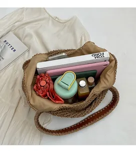 Top view of large woven tote bag showing spacious interior with books and tablet