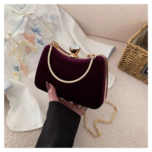 Elegant deep purple velvet clutch bag with gold frame and crystal clasp for formal dinner