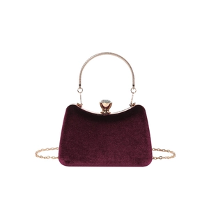Elegant burgundy velvet handbag with golden metal handles and a chain strap
