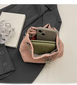 Top view of pink pleated leather bucket bag showing interior space with phone and wallet