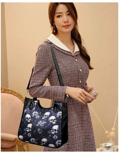 Detail view of large tote bag with skull and floral print on durable canvas material