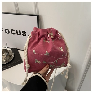 Fashionable plum red canvas drawstring crossbody bag with floral embroidery detail