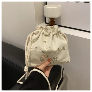 Elegant beige floral embroidery drawstring crossbody bag with woven straps for women