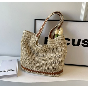 Fashionable woven straw tote bag with brown leather handles and base for women