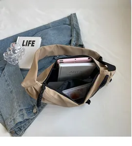 Interior view showing the large capacity and zipper pocket of the khaki nylon crossbody bag