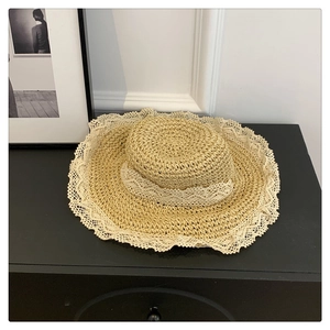 Handwoven straw sun hat with delicate white lace trim and minimalist pastoral style