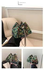 Detail view of colorful sequin bucket bag with silver chain and pearl tassel detail