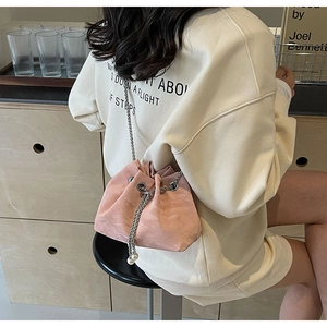 Pink velvet drawstring bucket bag with silver chain strap and pearl detail accents