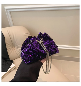 Close-up of purple sequin bucket bag featuring a silver chain and pearl ornament