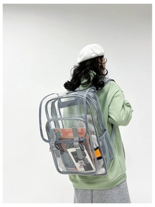 Detail of transparent PVC backpack with grey straps showing spacious interior compartments