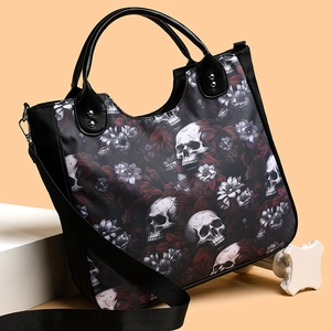 Black nylon crossbody bag with skull and flower print featuring double handles and strap