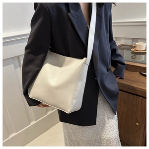Detail view of large capacity ivory white tote bag on shoulder for daily commute