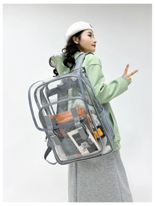 Detailed view of the clear PVC backpack featuring purple webbing and buckle details