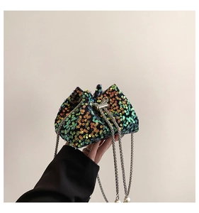 Detail of multi-color sequins and silver chain strap on a mini bucket bag