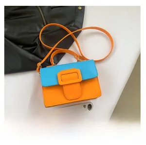 Detailed top view of contrast color square bag with size comparison to a smartphone