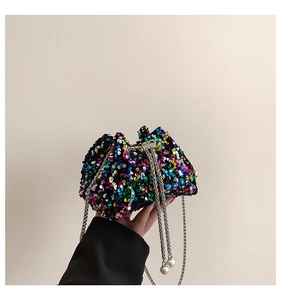 Close-up of vibrant multicolored sequins and elegant pearl drawstring on the bucket bag