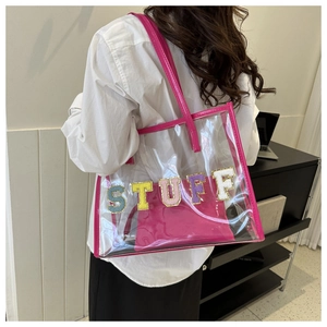 Detail of transparent PVC tote with pink patent leather trim and STUFF embroidery