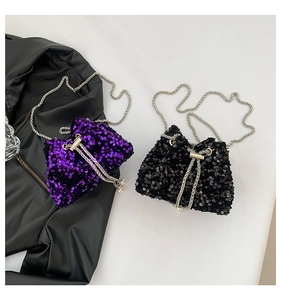 Close-up of sequin bucket bags in purple and black with silver chains and pearls
