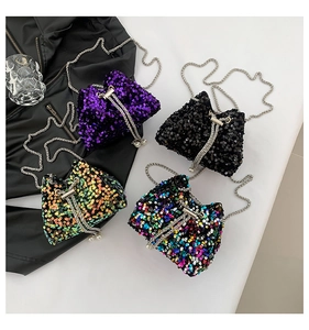 Detail of sequined bucket bags in purple and black with metal chains and pearl charms
